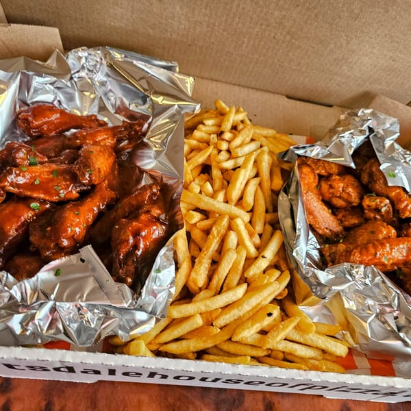 Hartsdale House of Pizza's chicken wings and french fries in a takeout box.
