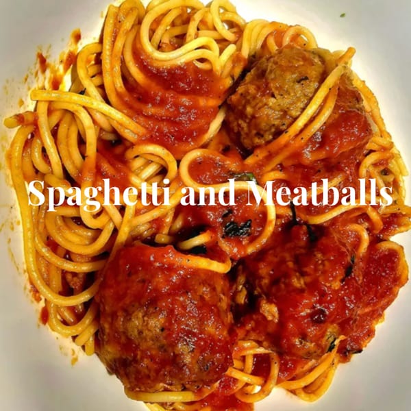 A close-up of spaghetti and meatballs with red sauce in a white bowl from Hartsdale House of Pizza.