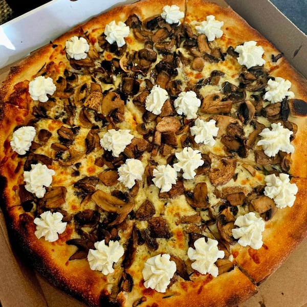 Hartsdale House of Pizza's mushroom pizza with dollops of ricotta cheese in a delivery box.
