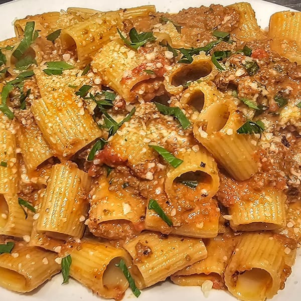 Rigatoni pasta with meat sauce, grated cheese, and fresh basil from Hartsdale House of Pizza.
